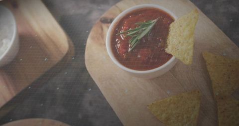 Rustic Tomato Salsa with Rosemary and Tortilla Chips on Wooden Board Closeup