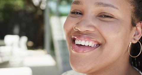 Joyful Biracial Woman Smiling Outdoors in Sunlight - Download Free Stock Images Pikwizard.com