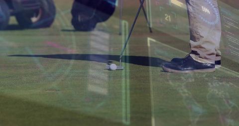 Putting close-up showing golfer aligning putter and ball on sunny green with tech overlay