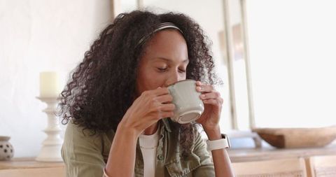 Woman Enjoying Tea at Home in Minimalist Interior