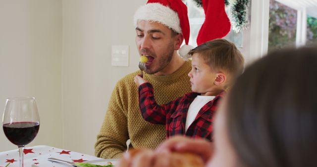 Father and Son Enjoying Christmas Meal Together - Download Free Stock Images Pikwizard.com