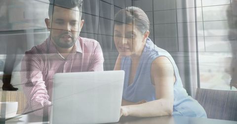 Professional Team Collaboration at Office Desk by Large Windows