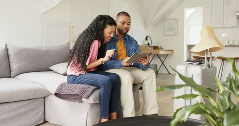 Couple planning vacation on tablet