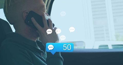 Man in Parked Car Responding to Numerous Messages on Smartphone