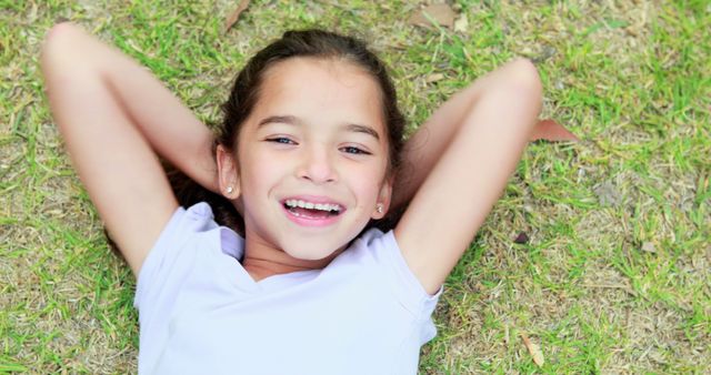 Happy Girl Relaxing on Grass with a Bright Smile - Download Free Stock Images Pikwizard.com