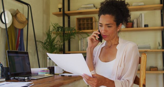 Confident Businesswoman Discussing Paperwork in Home Office - Download Free Stock Images Pikwizard.com