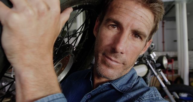 Close-up of Male Mechanic Working on Motorcycle Wheel in Garage - Download Free Stock Images Pikwizard.com