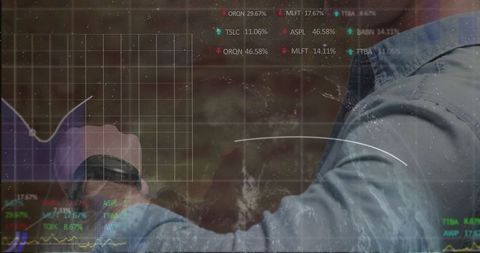 Businessman analyzing stock charts on transparent display