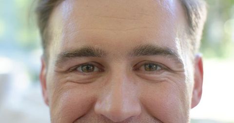 Closeup male portrait showing natural skin texture and brown eyes in soft window light