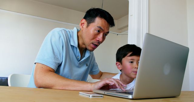 Father Helping Son with Online Homework on Laptop at Home - Download Free Stock Images Pikwizard.com