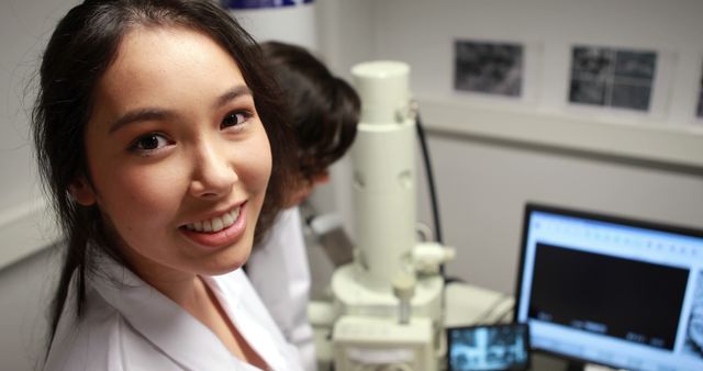 Smiling Female Scientist Using Microscope in Laboratory - Download Free Stock Photos Pikwizard.com