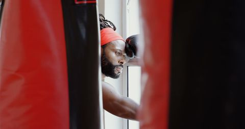 Contemplative boxer preparing in gym studio