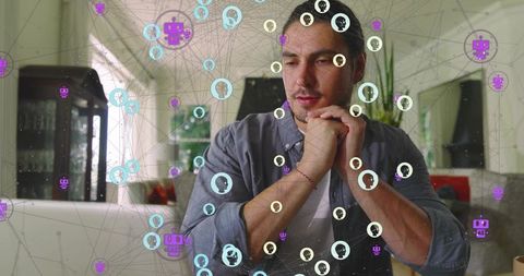 Contemplative remote professional analyzing digital network overlay sitting home workspace