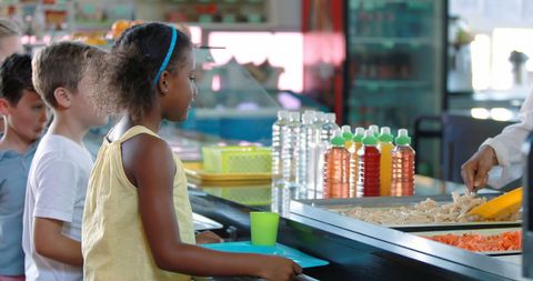 Children receiving lunch in school cafeteria