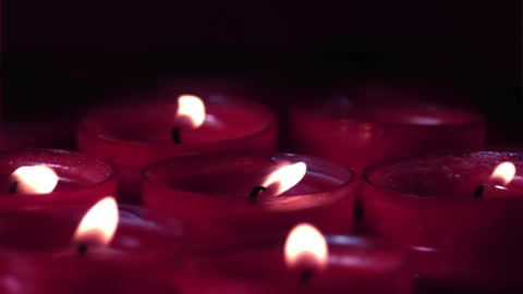 Slow Motion Flickering Red Candles in Dark Serenity