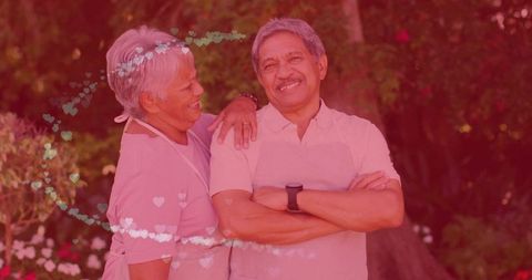 Senior Couple in Garden Wearing Aprons Embracing Wellness and Love