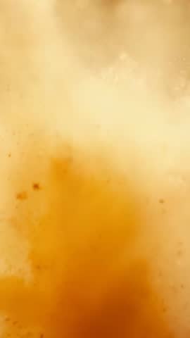 Vertical slow-motion eruption sending orange dust cloud expanding with airborne particles