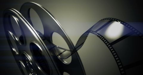 Film Reel with Unraveling Film Strip on Abstract Background