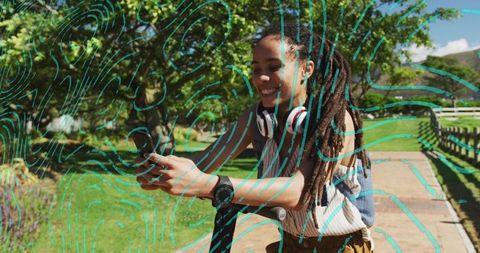 Woman Using Smartphone on Scooter in Park with Headphones On Sunny Day