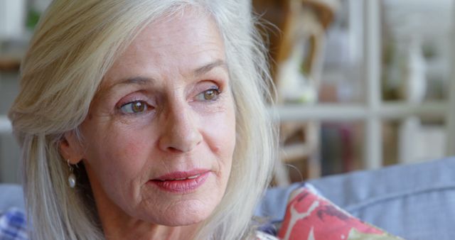 Thoughtful Senior Woman with Gray Hair Sitting Indoor - Download Free Stock Images Pikwizard.com