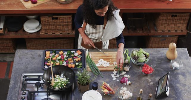 Woman Chopping Vegetables in Modern Kitchen while Using Tablet - Download Free Stock Images Pikwizard.com