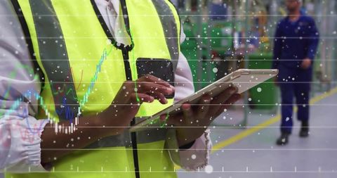 Factory engineer using tablet for machine monitoring