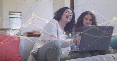 Diverse mother and preteen daughter using laptop with data overlay for remote learning