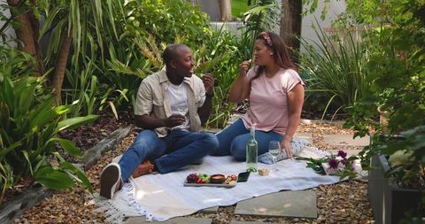 Diverse Couple Enjoying Outdoor Picnic with Wine