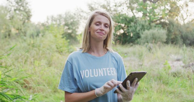 Happy Female Volunteer Using Tablet in Nature - Download Free Stock Images Pikwizard.com