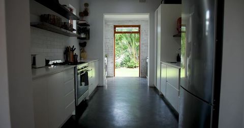 Contemporary galley kitchen with outdoor garden view