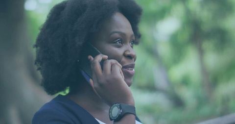 Woman Talking on Smartphone Outdoors Wearing Smartwatch