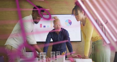 Diverse Team Analyzing Market Trends with Data Visualization