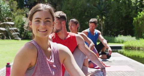 Group Enjoying Outdoor Yoga Session in Peaceful Park Environment