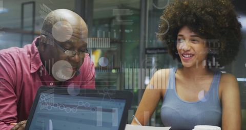 Diverse colleagues discussing data in office with digital interface