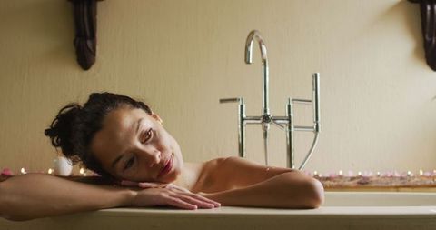 Young Female Relaxing in Luxury Bathtub