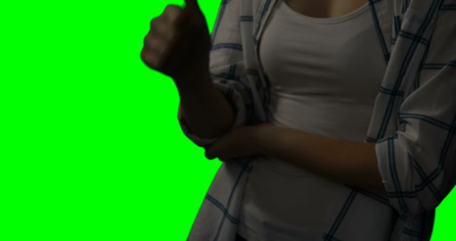 Person giving thumbs up gesture, with arm crossed, over green screen background; suitable for use in video edits, presentations, or any design that requires a cut-out person showing approval.