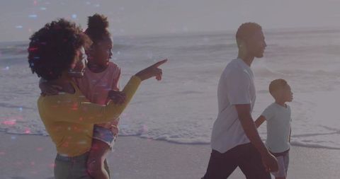 Family Enjoying Leisurely Beach Walk During Golden Hour
