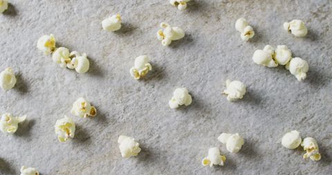Close-Up of Scattered Popcorn on Gray Surface - Download Free Stock Images Pikwizard.com