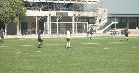 Soccer Team Practicing on Field Displaying Teamwork and Strategy