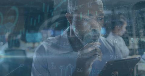 Businessman Analyzing Data on Tablet with Digital Interface Overlay