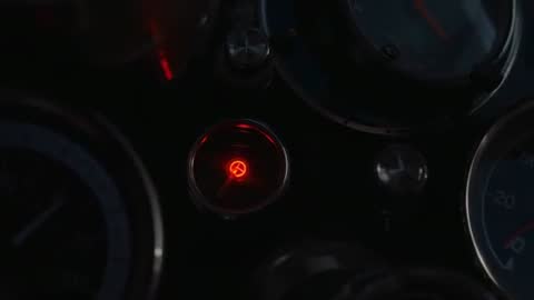 Glowing Red Warning Lamp Pulsing on Vintage Car Instrument Cluster at Night