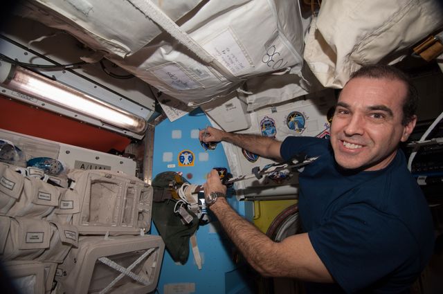 ISS039-E-020702 (13 May 2014) ---  NASA astronaut Rick Mastracchio, Expedition 39 flight engineer, places his crew patch on the wall in the Quest airlock of the Earth-orbiting International Space Station, continuing a Quest-based tradition of station crew members who have participated in space walks on their current flights. A short time later, Mastracchio joined Expedition 39 Commander Koichi Wakata of the Japan Aerospace Exploration Agency and Flight Engineer Mikhail Tyurin of Roscosmos as they departed the orbital outpost in a Soyuz vehicle.