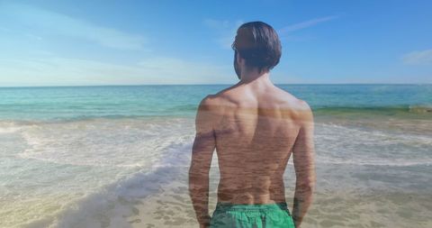 Man Facing Calming Blue Sea on Sunny Beach Day - Download Free Stock Images Pikwizard.com