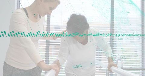 Caregiver assisting senior patient walking on parallel bars during rehabilitation session