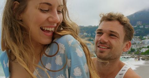 Joyful Couple Enjoying Bicycle Ride Along Beachside
