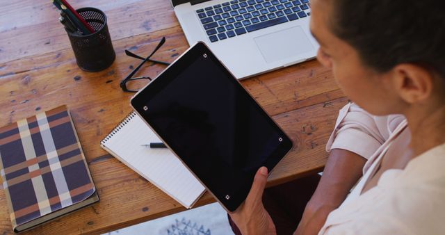 Businesswoman Working at Table with Tablet and Laptop - Download Free Stock Images Pikwizard.com