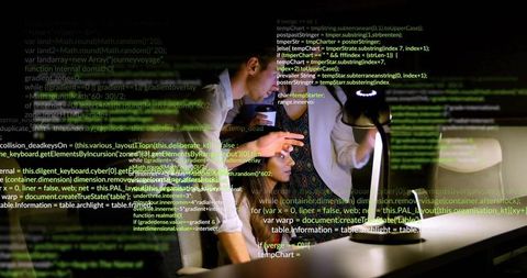 Team Collaboration over Code in Modern Office at Night