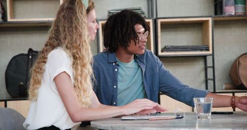 Project collaboration at modern office desk: diverse professional teamwork