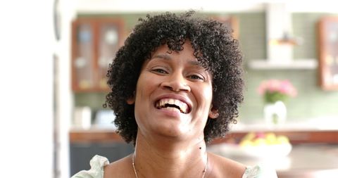 Joyful Woman Smiling Brightly in Sunlit Room - Download Free Stock Images Pikwizard.com