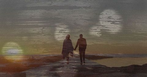 Romantic Couple Holding Hands during Serene Sunset Walk